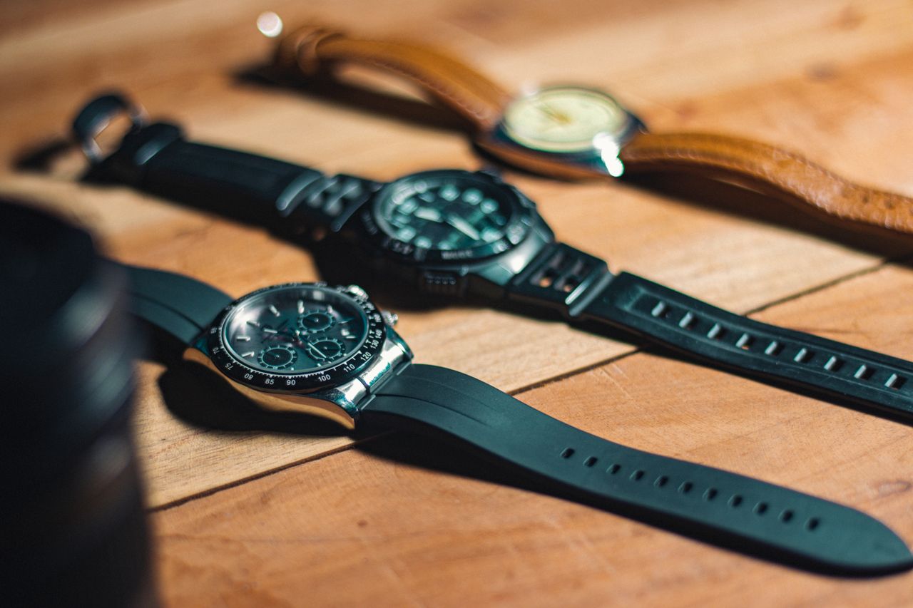 about-us Close-up of elegant analog wristwatches on a wooden surface, showcasing style and craftsmanship.